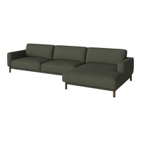 Modern dark green sectional sofa with clean lines and a minimalist design, featuring soft textured upholstery.