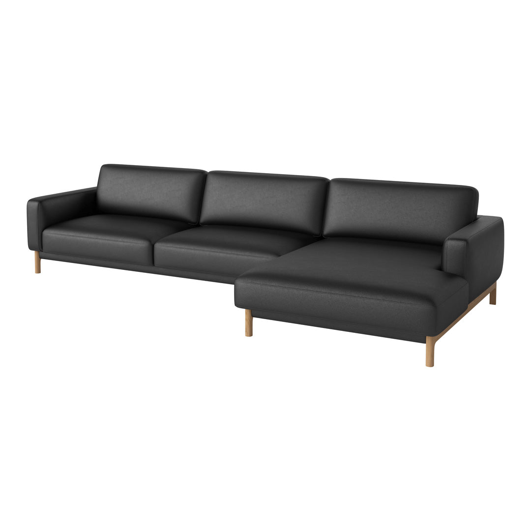 Modern black sectional sofa with clean lines and wooden legs, featuring a sleek, minimalist design.