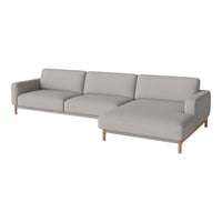 Light gray sectional sofa with clean lines and wooden legs, featuring a minimalistic design and soft upholstery.