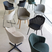 Assorted chairs in beige, green, gray, and black with unique textures and patterns. Modern design for any interior.