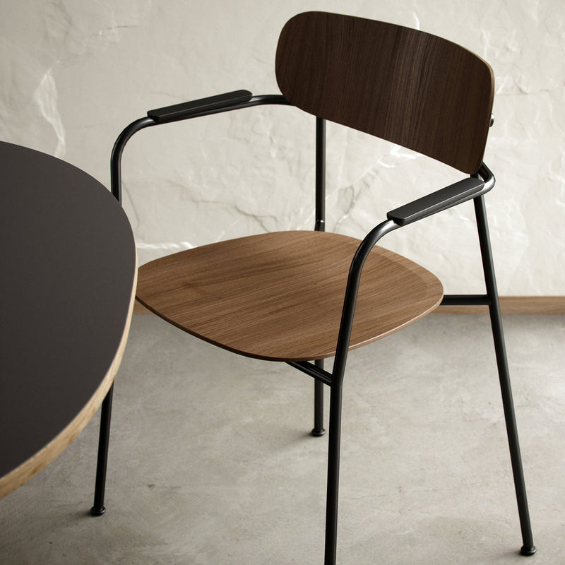 Modern chair featuring a warm wood tone seat and backrest with sleek black metal legs against a neutral backdrop.