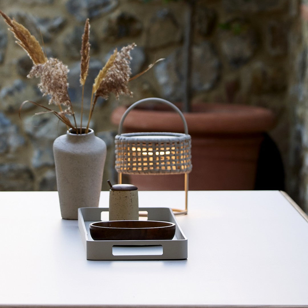 Elegant neutral tones with earthy textures and soft patterns in a minimalist tabletop decor setting.