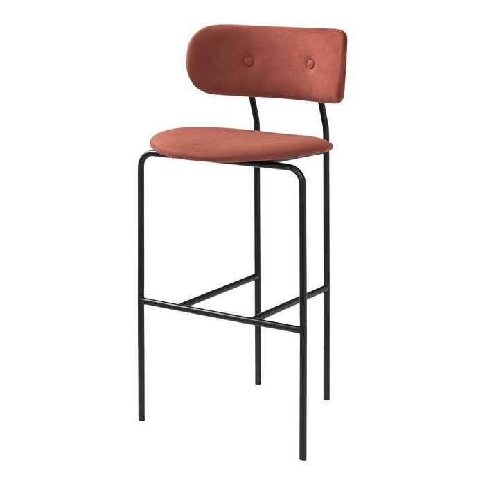 "Rust-colored upholstered bar stool with a sleek black metal frame and minimalistic design."
