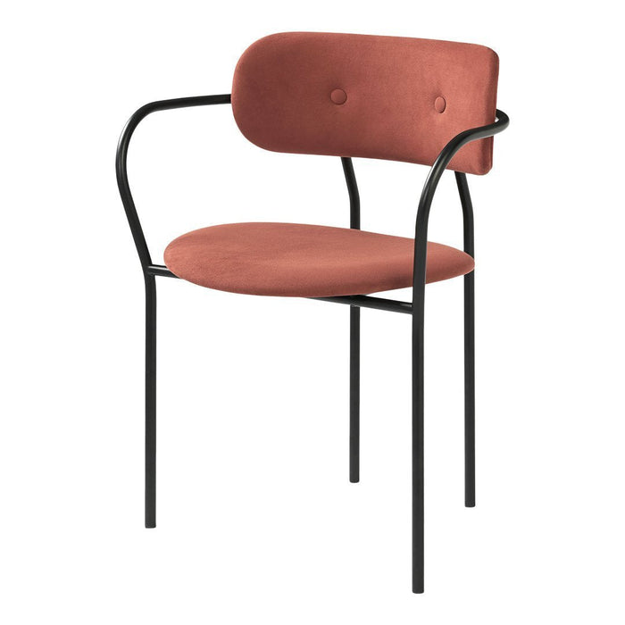 Rose-colored upholstered chair with black metal frame and button detailing. Sleek, modern design for stylish interiors.