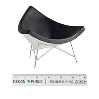 Modern chair featuring a sleek black leather seat and a contrasting white base, supported by metallic legs.