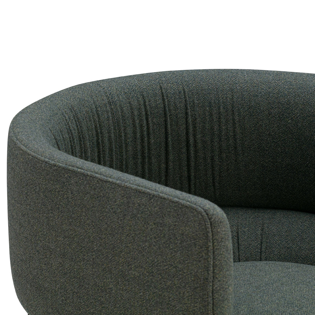 Textured dark green armchair with a curved shape and subtle vertical stripes for added depth and style.