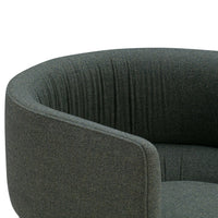 Textured dark green armchair with a curved shape and subtle vertical stripes for added depth and style.