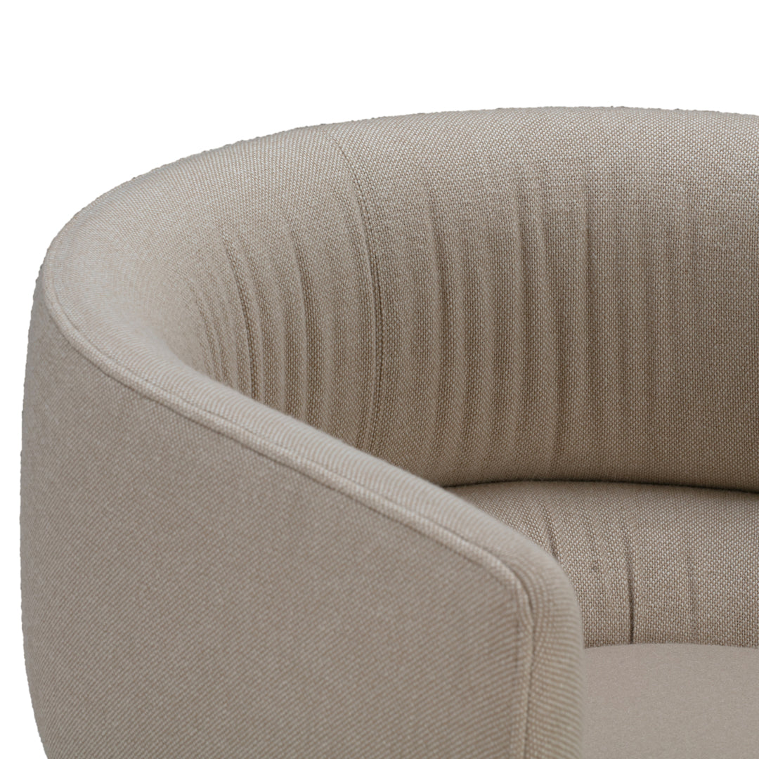 Beige curved chair with subtle ribbed pattern, adding a touch of texture to modern interiors.