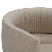 Beige curved chair with subtle ribbed pattern, adding a touch of texture to modern interiors.