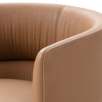 Tan leather armchair featuring smooth, ribbed upholstery and rounded armrests for a modern, elegant look.