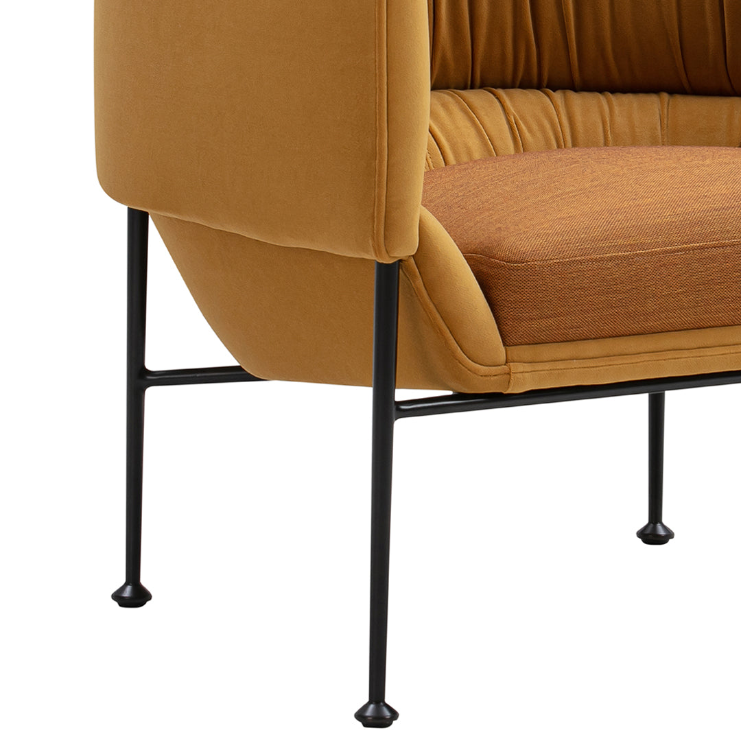 Stylish mustard yellow upholstery with ribbed brown fabric accents, supported by sleek black metal legs.
