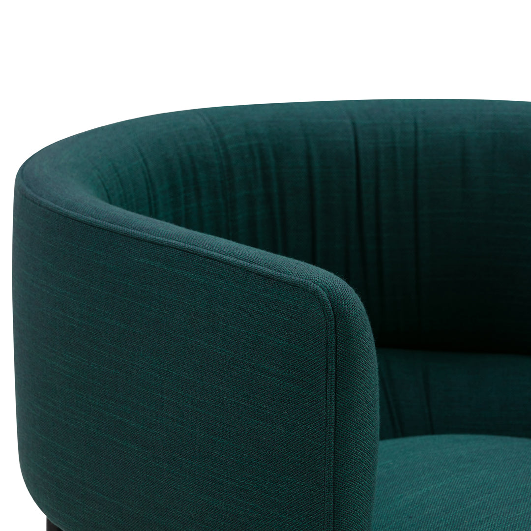 Luxurious dark teal fabric armchair with a smooth, textured finish and sleek curved design. Perfect for modern decor.