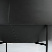 Black leather chair with subtle stitching details and a sleek modern design, set on thin black metal legs.