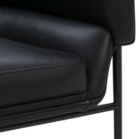 Black leather armchair seat with smooth texture and minimalist black metal frame. Elegant and modern design.