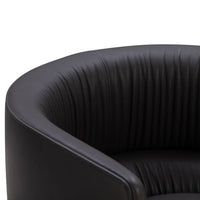 Black leather armchair with ribbed pattern, offering a sleek and modern aesthetic. Perfect for contemporary spaces.