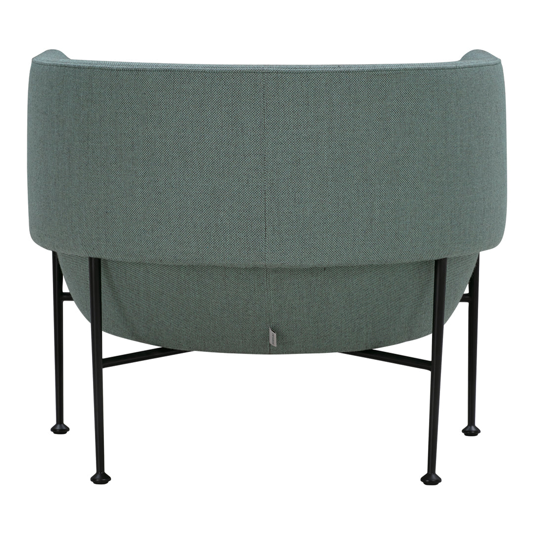 Mint green curved chair with ribbed texture and black metal legs, showcasing modern design and elegant simplicity.