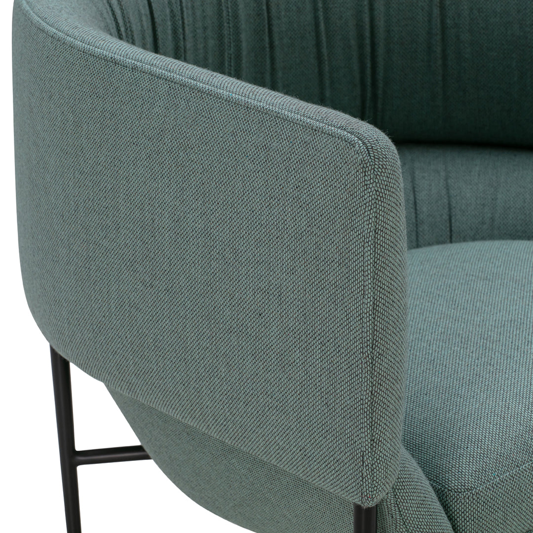 Teal green upholstered chair with textured fabric and sleek black metal legs, featuring a modern design.