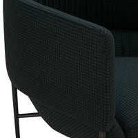 Dark green and black woven fabric featuring a subtle checkered pattern on a modern chair armrest.