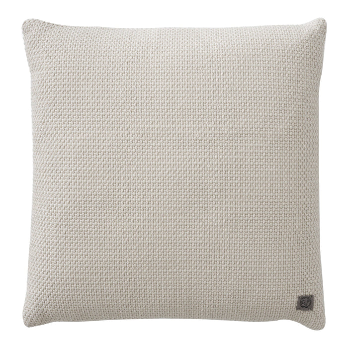 Cream textured throw pillow with a subtle woven pattern, perfect for home décor accents.