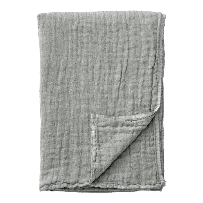 Soft grey muslin blanket with a textured, wrinkled pattern, perfect for cozy spaces and stylish décor.