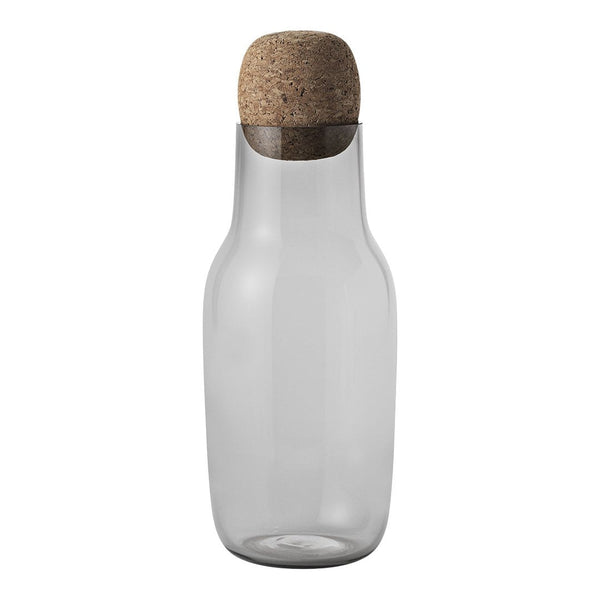 Clear glass water carafe with a natural cork stopper, showcasing a sleek and modern design.