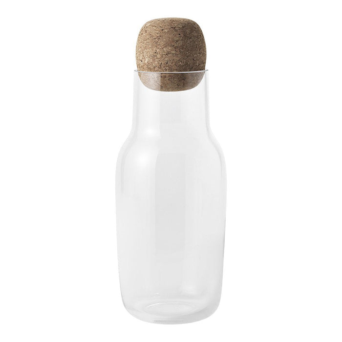 Clear glass carafe with a natural cork lid, showcasing minimalist design and neutral tones. Perfect for any table setting.