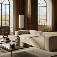 Modern beige sectional sofa with smooth texture, complemented by elegant neutral tones and minimalist decor.