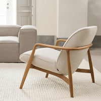 Light beige armchair with a natural wood frame, featuring a smooth, minimalist design and textured upholstery.