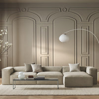 Beige sectional sofa with textured fabric, complemented by neutral pillows against a soft taupe wall.
