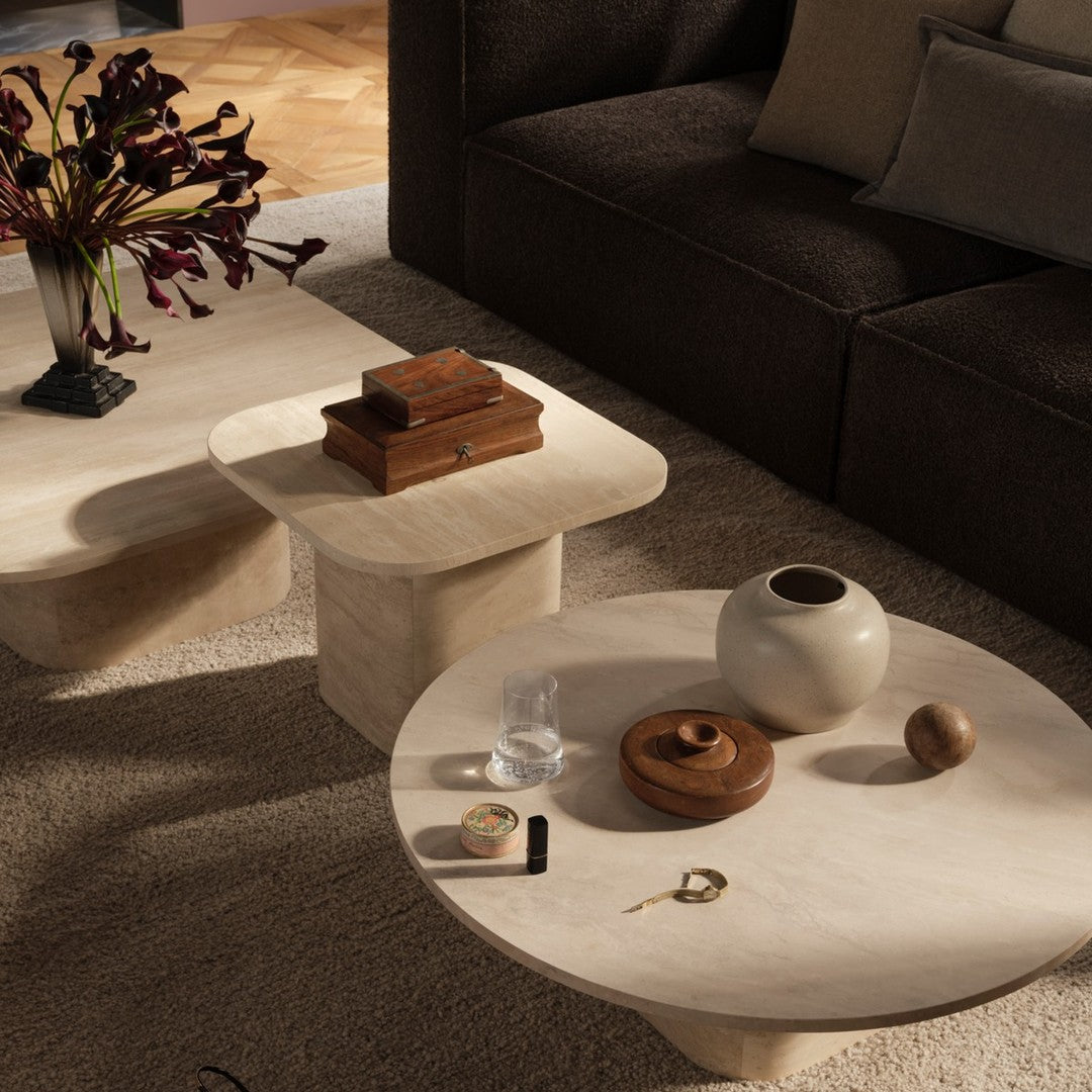 "Light beige and soft cream textured tables with minimalist design, accented by dark wood and earthy tones."