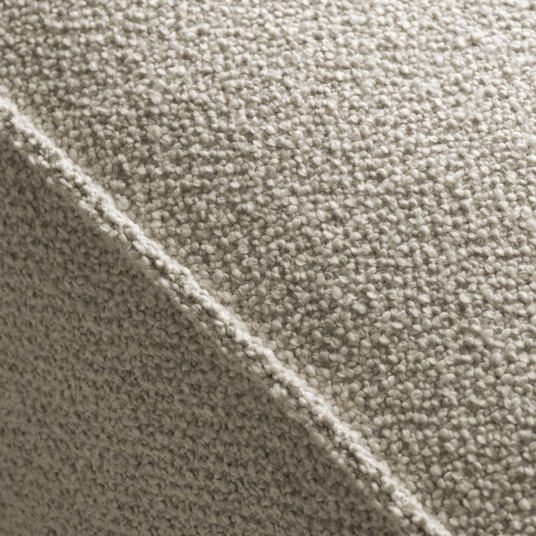 Textured beige fabric with a soft, fuzzy pattern and subtle variation in tones for a cozy look.