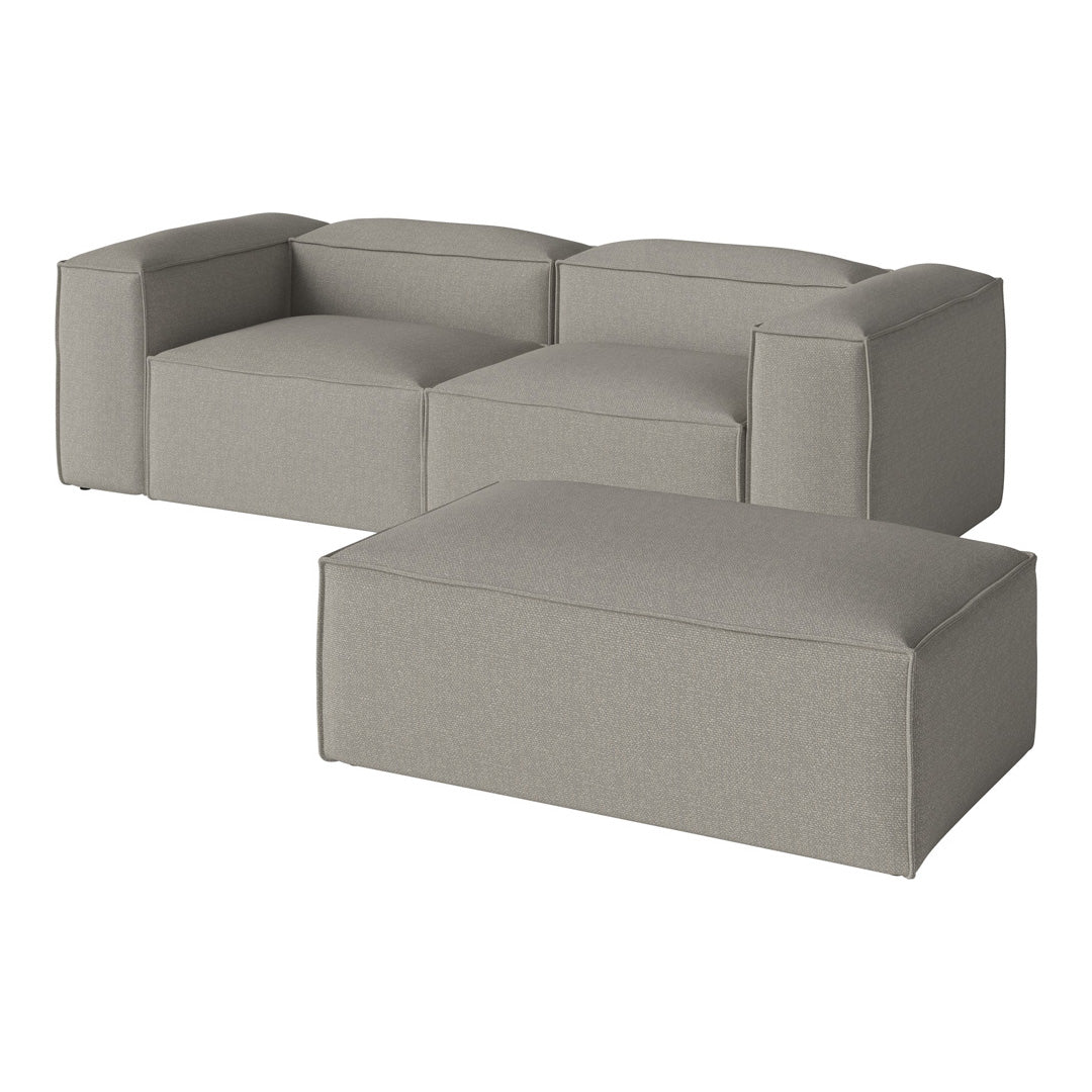Light gray modular sofa with smooth, minimalist design and contrasting textured ottoman. Perfect for modern spaces.