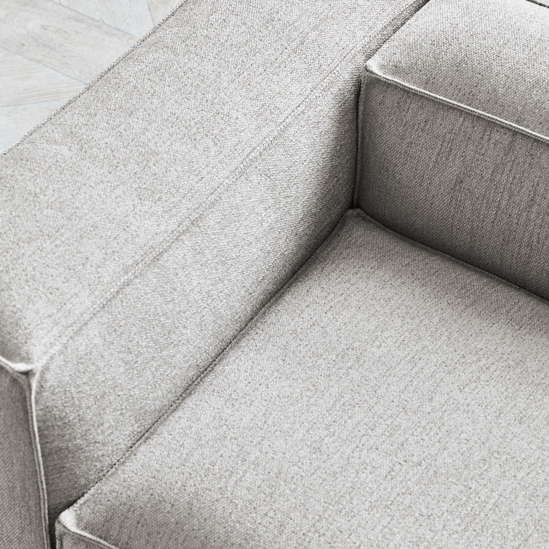 Light gray textured fabric upholstery with subtle woven patterns, perfect for modern home decor.