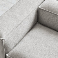 Light gray textured fabric upholstery with subtle woven patterns, perfect for modern home decor.
