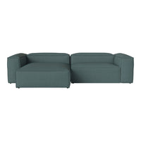 Teal sectional sofa with a minimalist design and solid color upholstery, featuring clean lines and modern aesthetics.