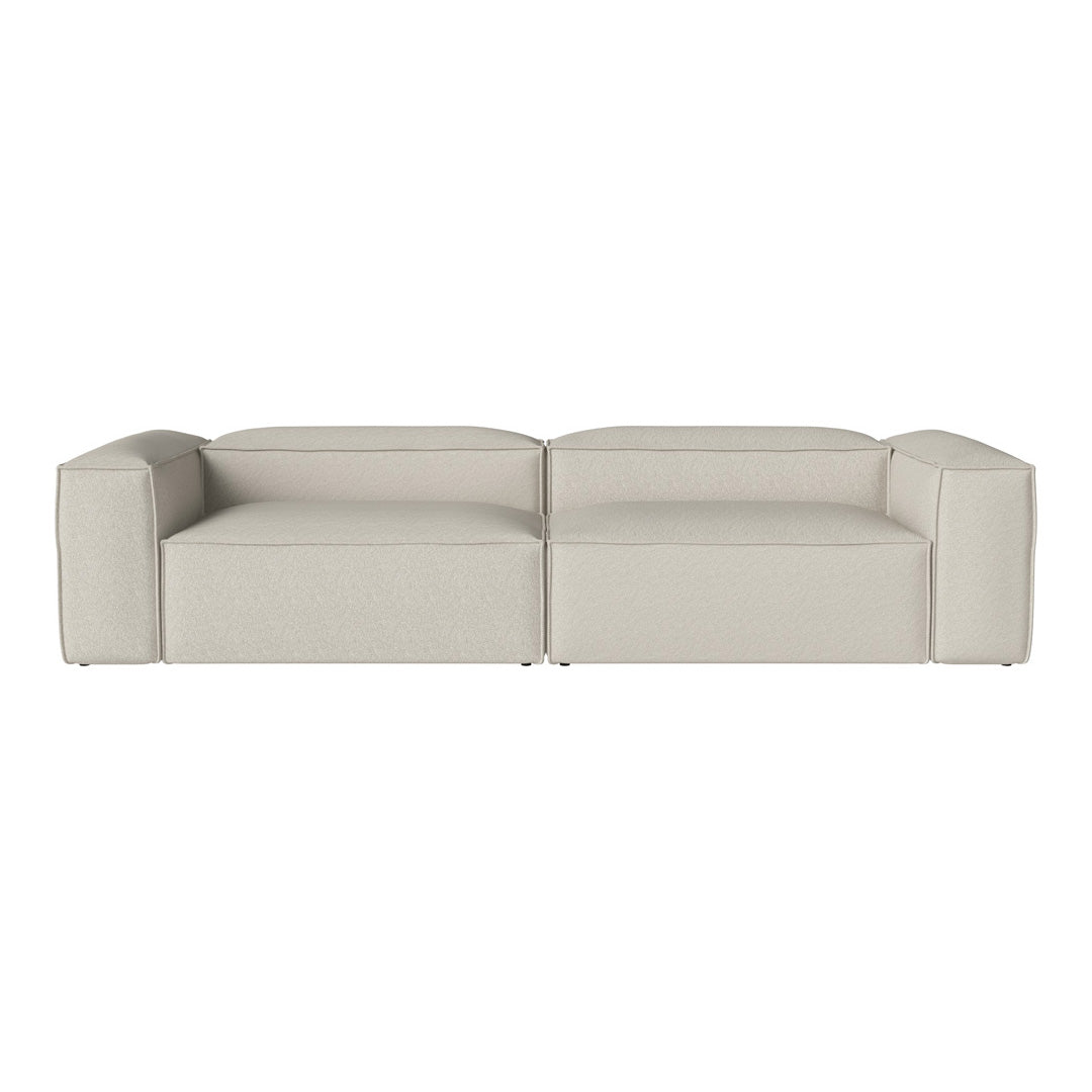 Modern, minimalist sofa in soft beige with a sleek, streamlined design and smooth upholstery.