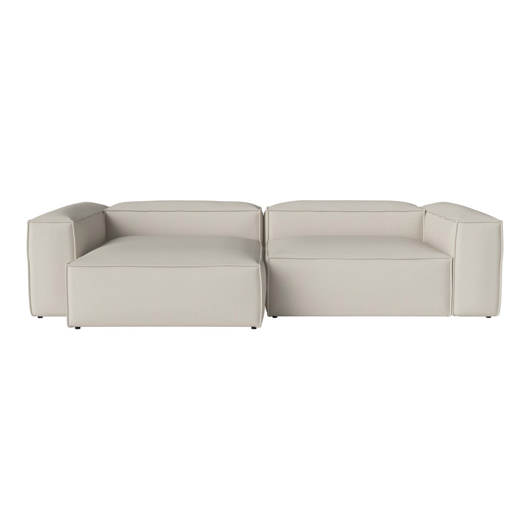 Modern modular sofa in a soft cream color with a sleek, minimal design. No patterns, just smooth textures.