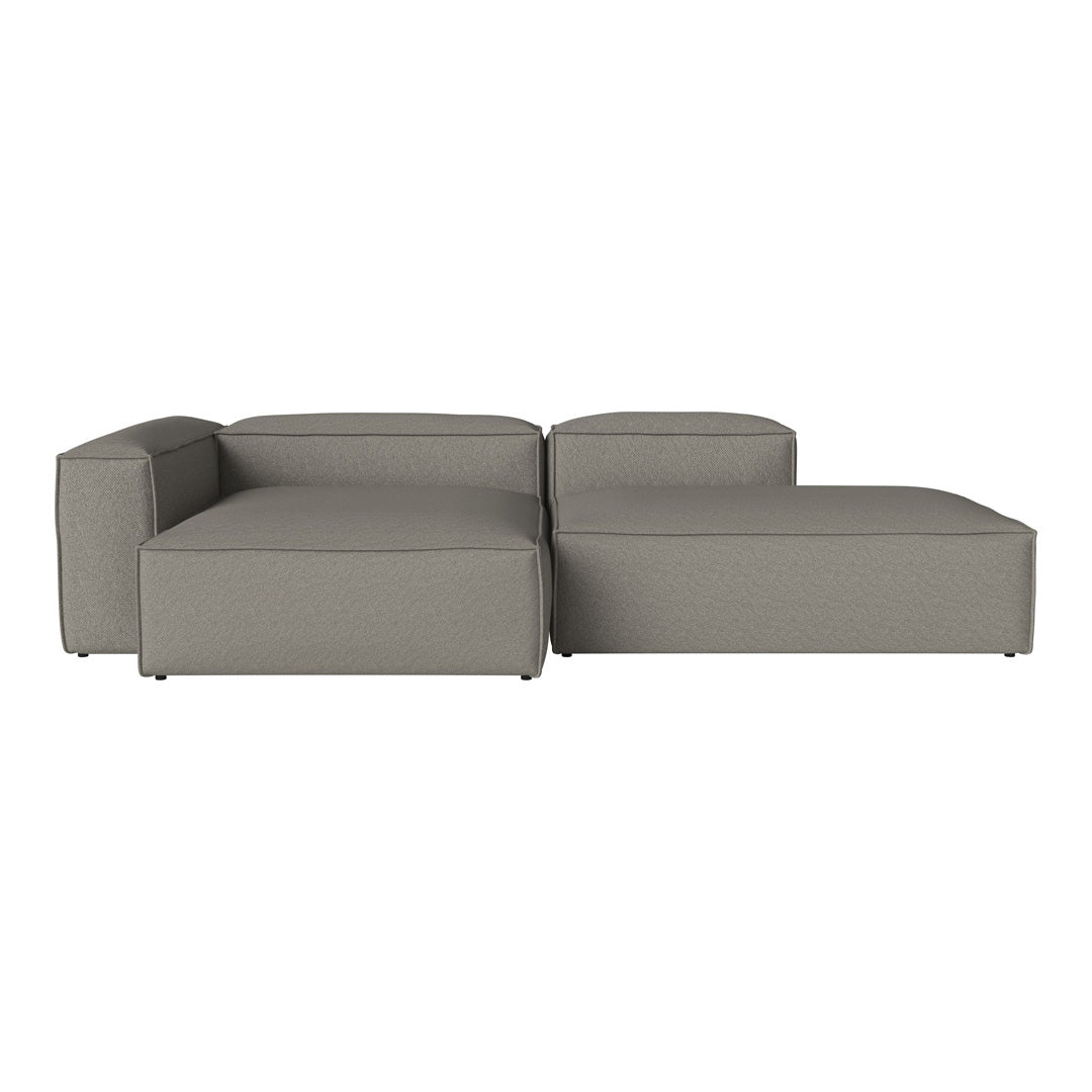 Modern grey sectional sofa with a sleek design and smooth fabric upholstery, featuring minimalist lines and no patterns.