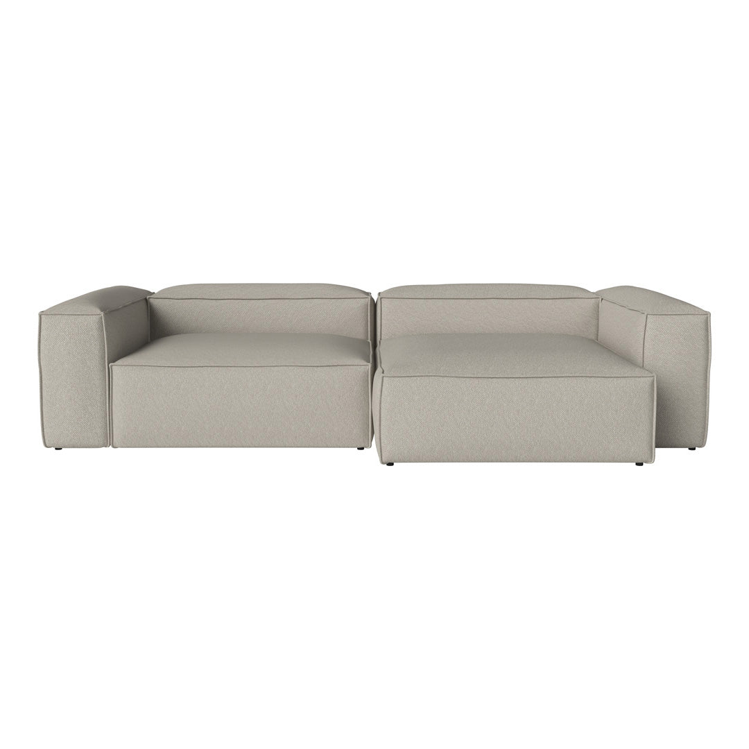 Modern gray sectional sofa with a minimalist design, featuring clean lines and a soft, textured fabric.