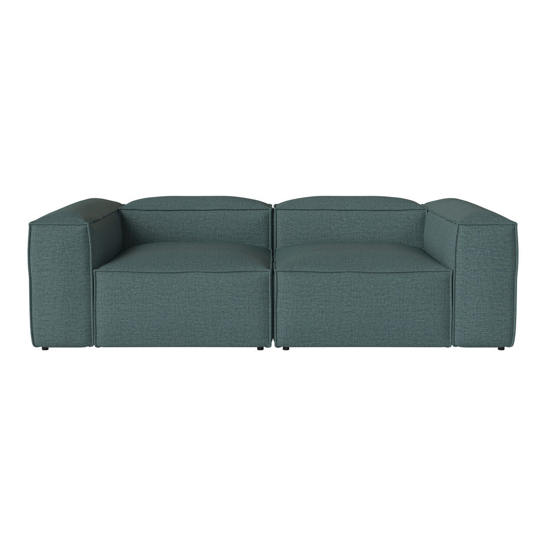 Teal lounge sofa with a modern, minimalist design and textured fabric, perfect for contemporary interiors.