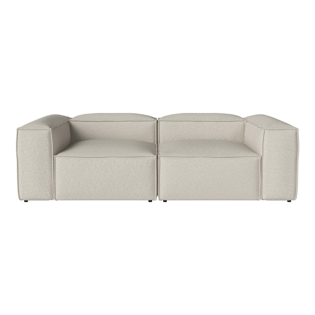 Light beige modular sofa with a smooth texture and contemporary geometric shape. Perfect for modern living spaces.