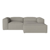 Gray sectional sofa with a smooth fabric texture and minimalistic design, featuring subtle stitching details.