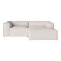 Modern white sectional sofa with a minimalist design, featuring smooth, clean lines and a neutral color palette.