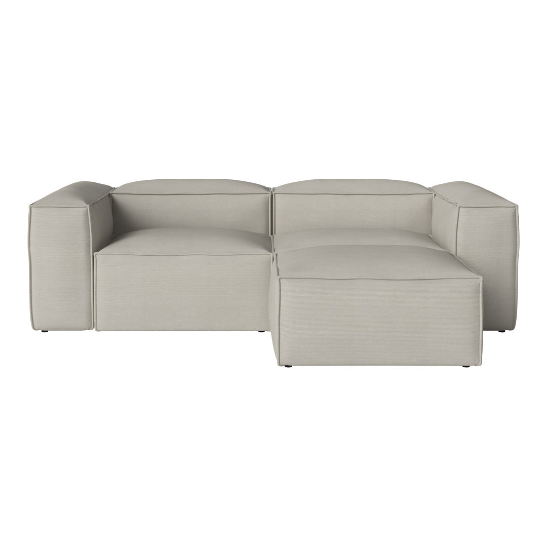 Light gray sectional sofa with smooth, modern lines and subtle textured fabric. Ideal for contemporary living spaces.