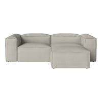 Light gray sectional sofa with smooth, modern lines and subtle textured fabric. Ideal for contemporary living spaces.