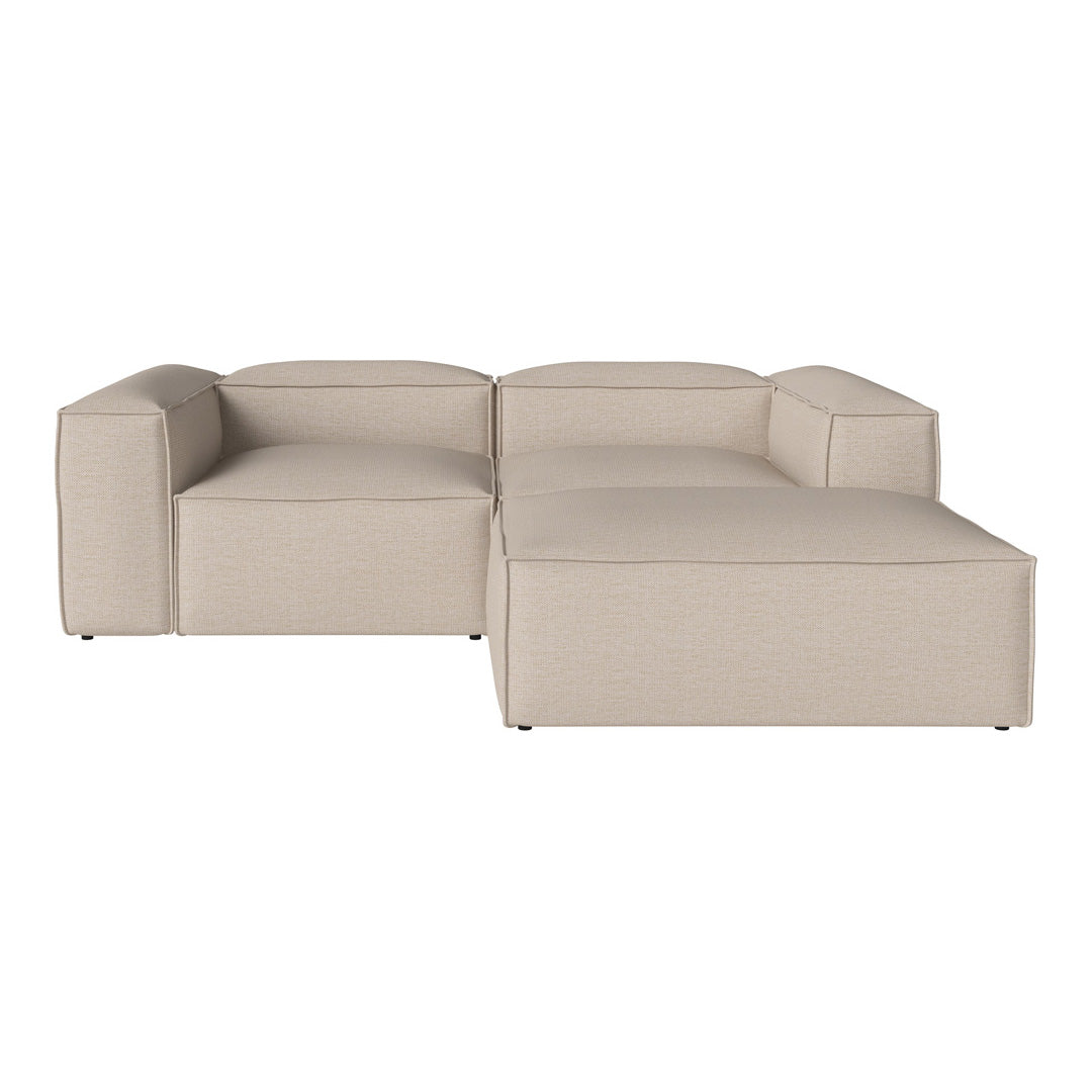 Beige sectional sofa with a minimalist design and clean lines, featuring a subtle textured fabric.