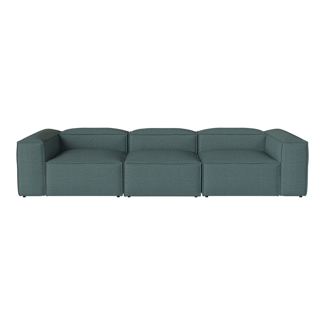 Modern modular sofa in a rich teal color with a simple, smooth fabric texture.