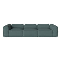 Modern modular sofa in a rich teal color with a simple, smooth fabric texture.