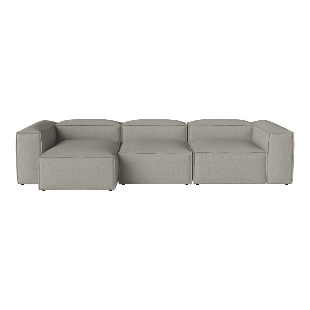 Modern sectional sofa in soft grey fabric with a sleek, minimalist design and clean lines.