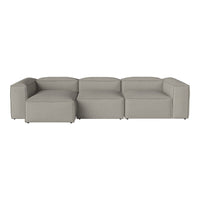 Modern sectional sofa in soft grey fabric with a sleek, minimalist design and clean lines.